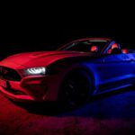 Mustang Auto - a red and blue mustang in the dark