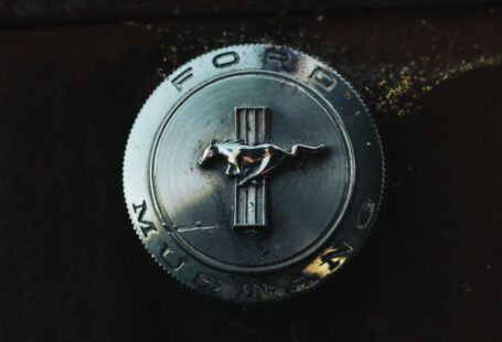 Mustang Auto - silver round coin with black cross