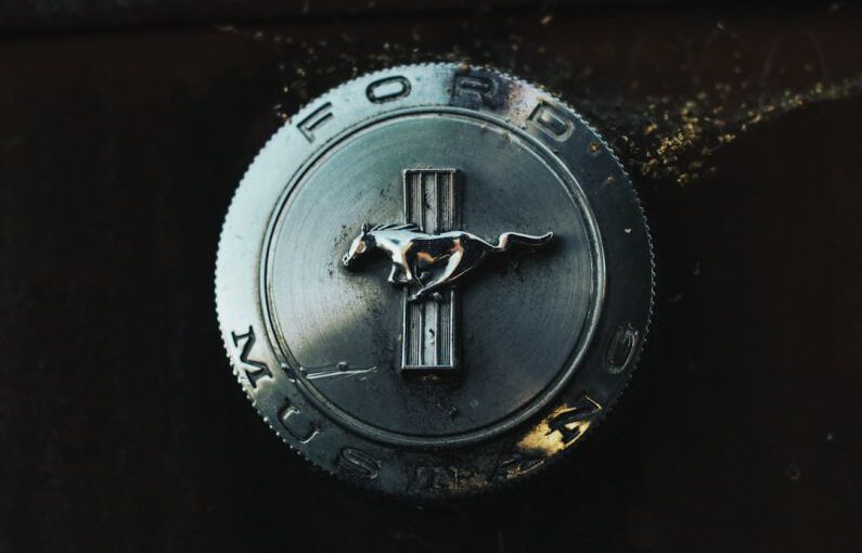 Mustang Auto - silver round coin with black cross