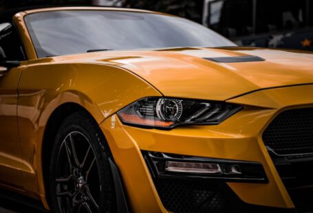 Mustang Auto - a close up of the front of a yellow sports car