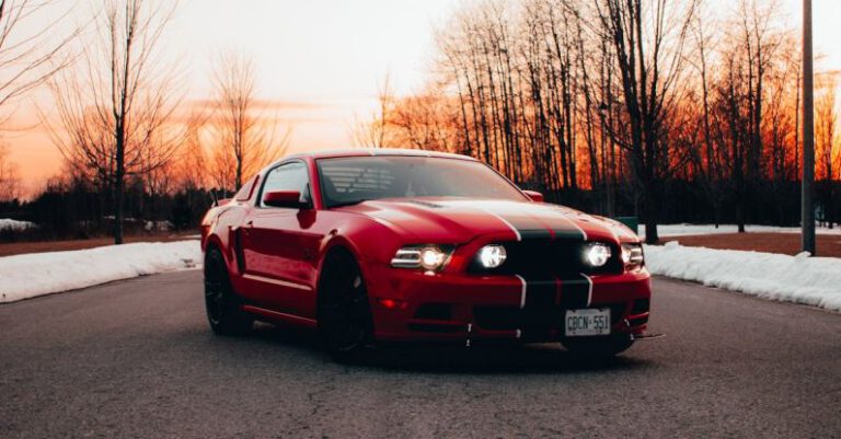 Mustang Auto - Red Sports Car on the Asphalt Road During Sunset