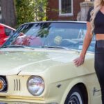 Mustang Auto - A Woman Standing Beside a Sports Car