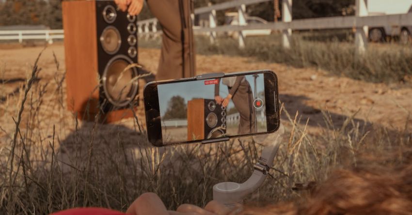 Mustang Performance Mods - A woman is taking a picture of a man playing music