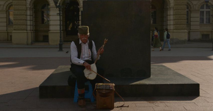 Mustang Performance Mods - A man playing a drum in front of a statue