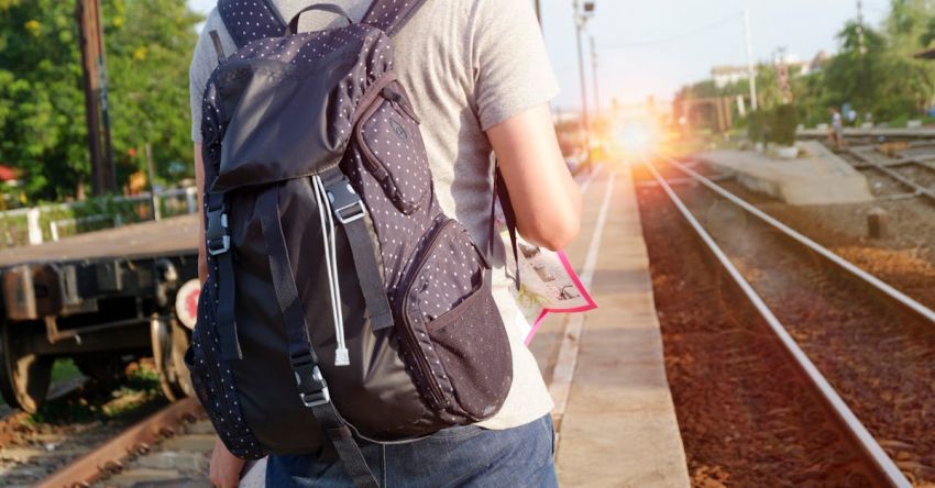 Mustang Track Days - Person in Grey Top With Backpack Waiting for Train