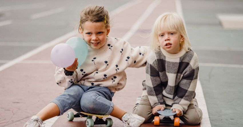 Mustang Track Days - Children sitting on skateboards on street