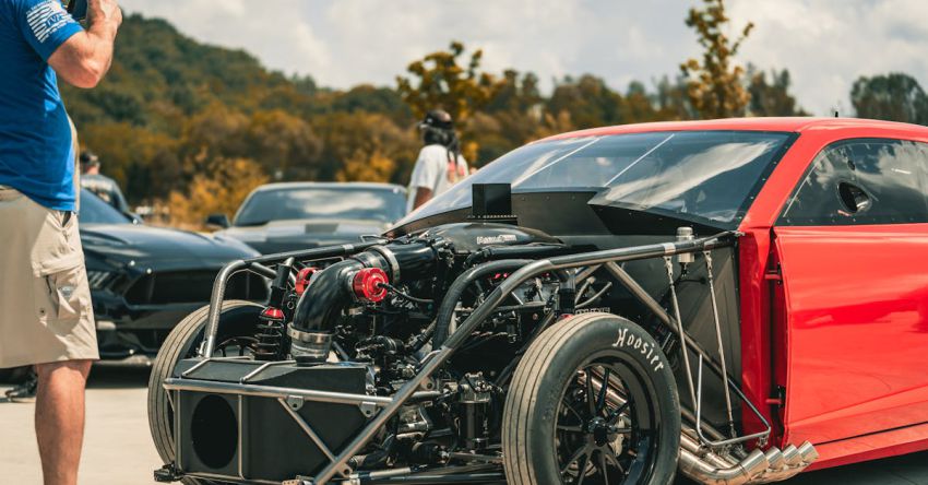 Mustang Engine Tuning - Man Photographing a Tuned Engine of a Racecar