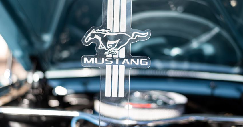 Mustang Engine Tuning - Close-up of Ford Mustang Sign on the Background of an Opened Car Hood